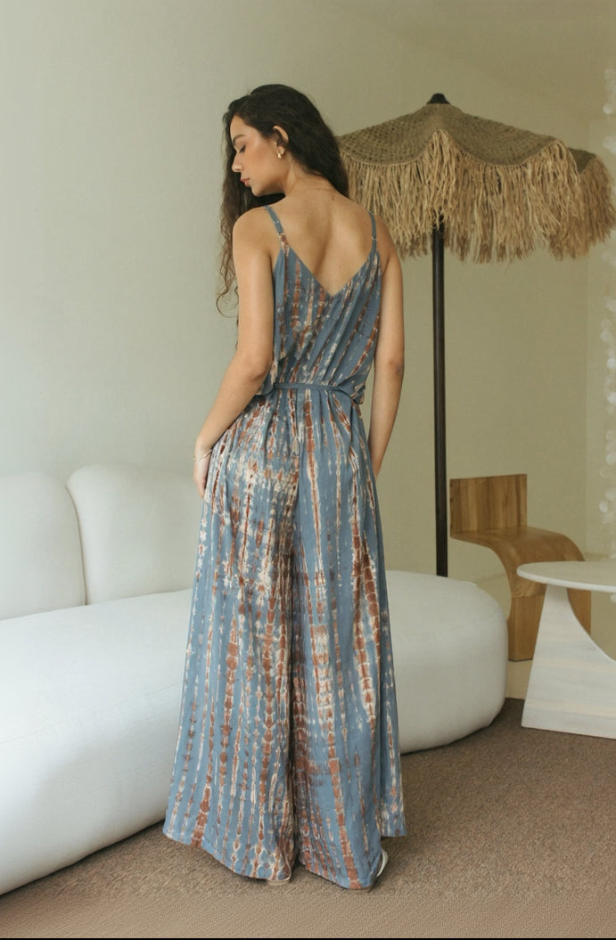 Back view of a relaxed-fit Bali tie-dye beachwear jumpsuit with a flowing wide-leg silhouette. - Tulalara