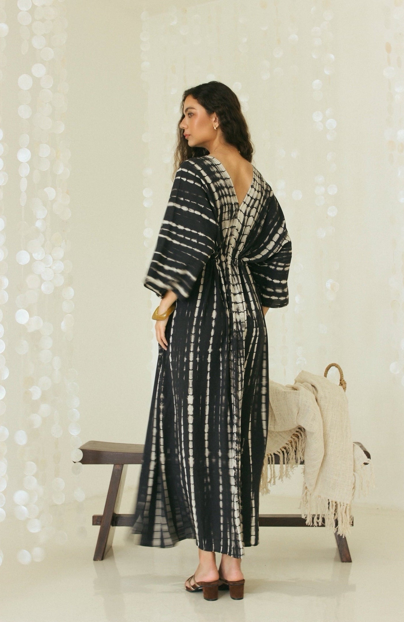 Back view of black Bali tie-dye maxi kaftan dress with open back detail - Tulalara