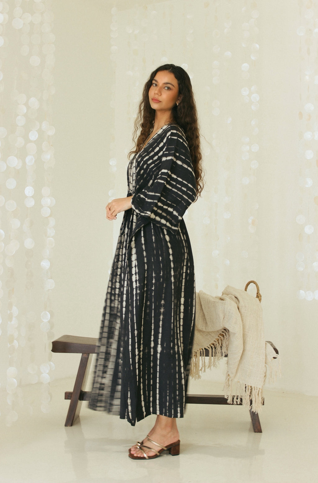 Side view of black Bali tie-dye maxi resort wear dress in relaxed silhouette - Tulalara