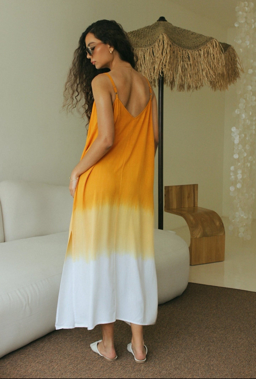 Back view of women’s gradient resort wear maxi dress featuring orange and white Bali tie-dye technique- Tulalara