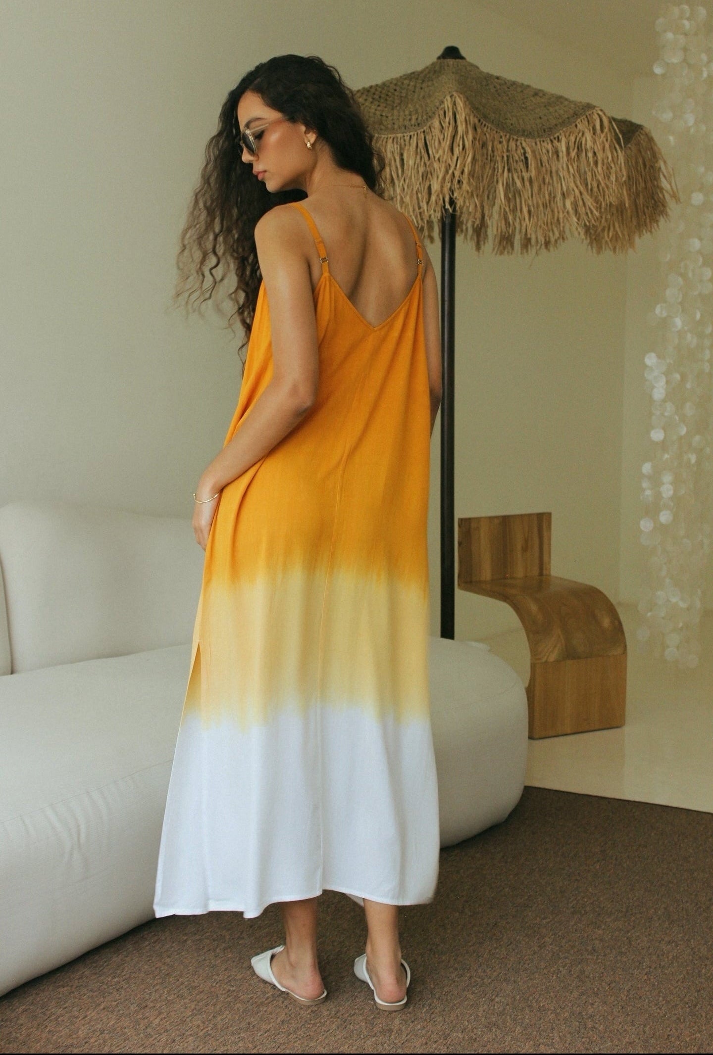 Back view of women’s gradient resort wear maxi dress featuring orange and white Bali tie-dye technique- Tulalara
