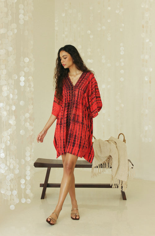 Front view of red Bali tie-dye mini kaftan dress with flowing silhouette