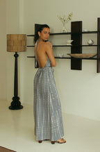 Back view of grey Bali tie-dye halter jumpsuit with open back detail - Tulalara