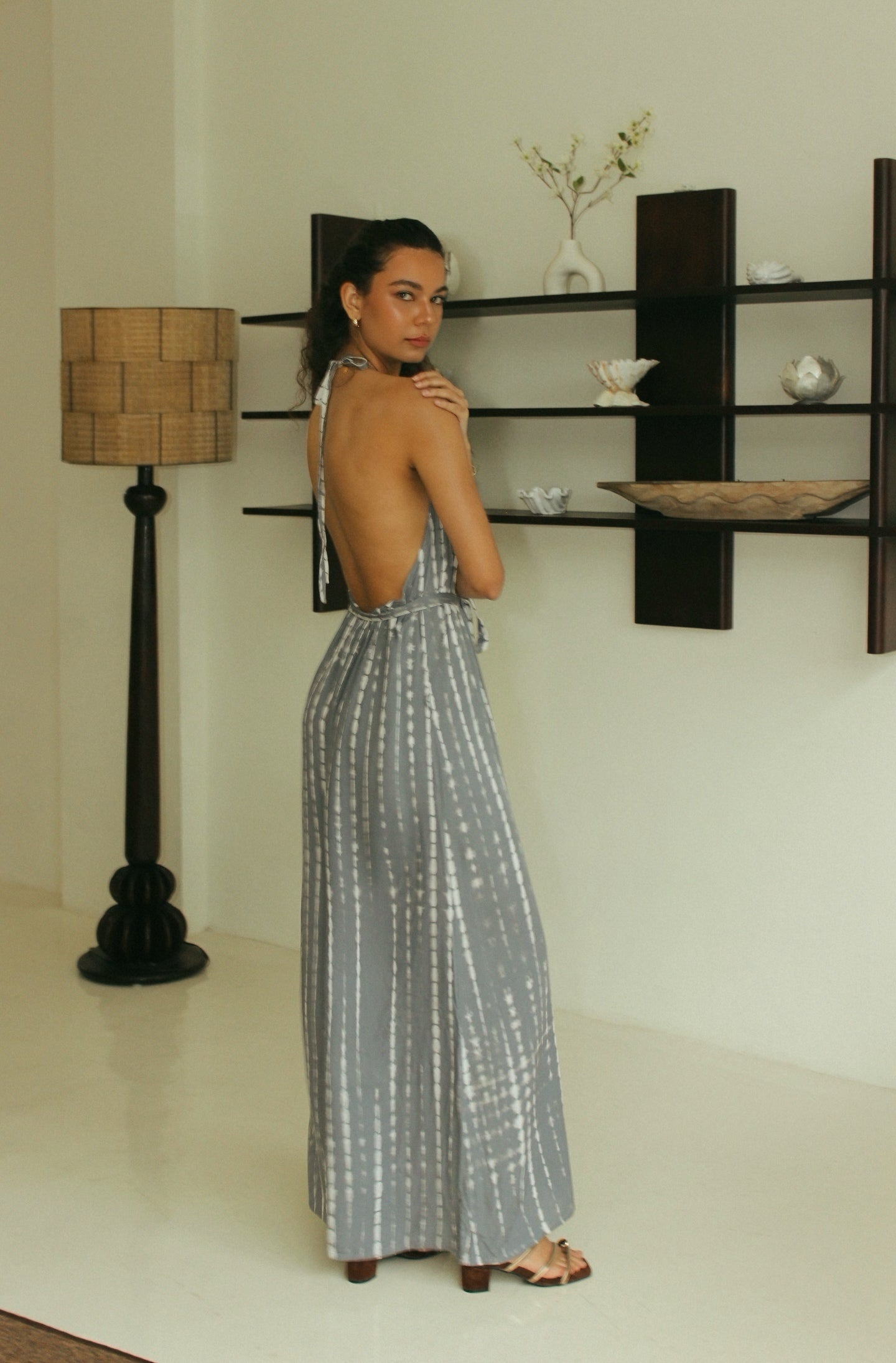 Back view of grey Bali tie-dye halter jumpsuit with open back detail - Tulalara