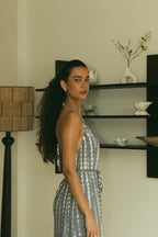 Elegant open-back resort wear jumpsuit in soft grey Bali tie-dye tones - Tulalara