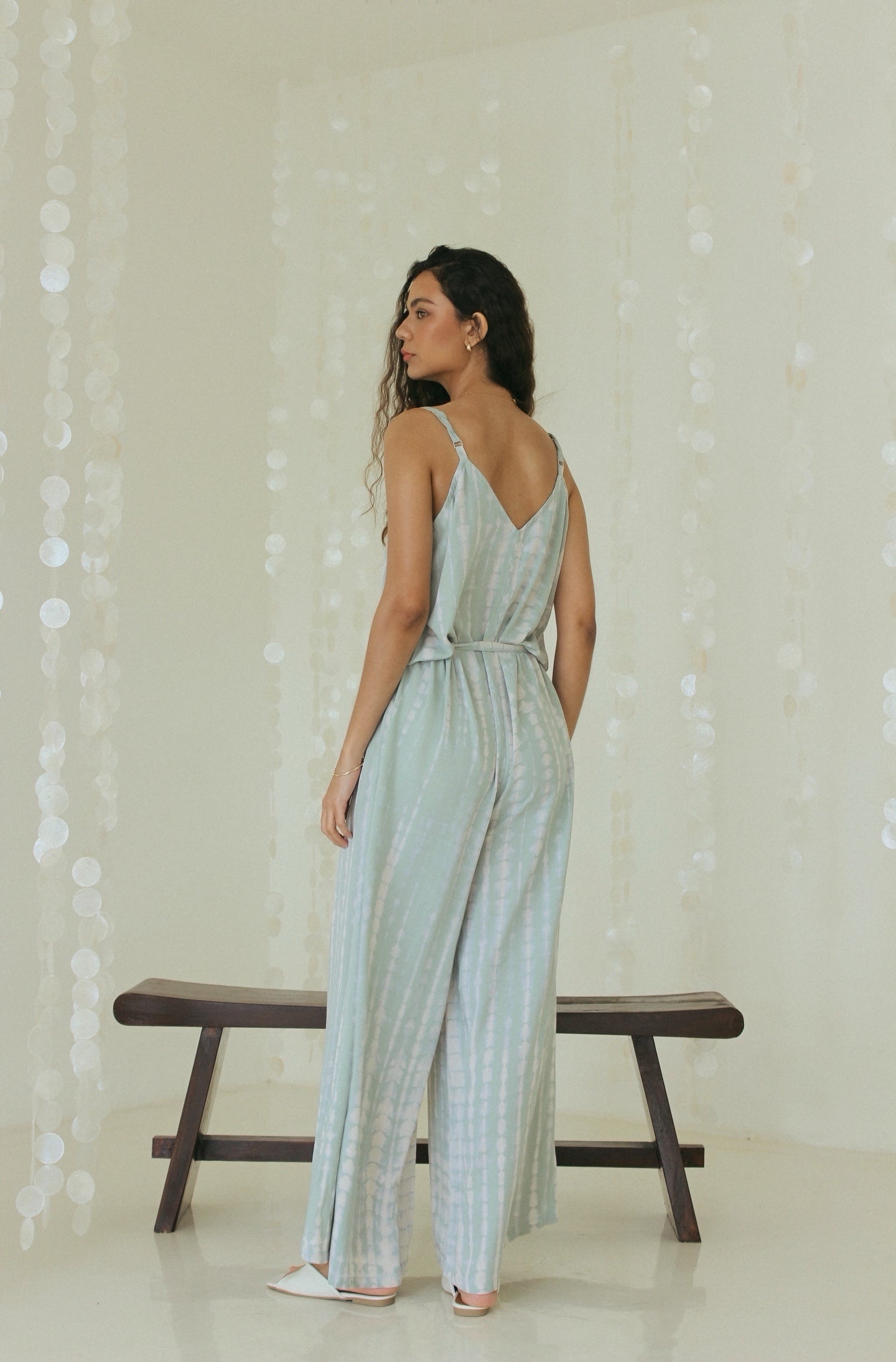 Back view of elegant Bali tie-dye beach jumpsuit with relaxed drape - Tulalara