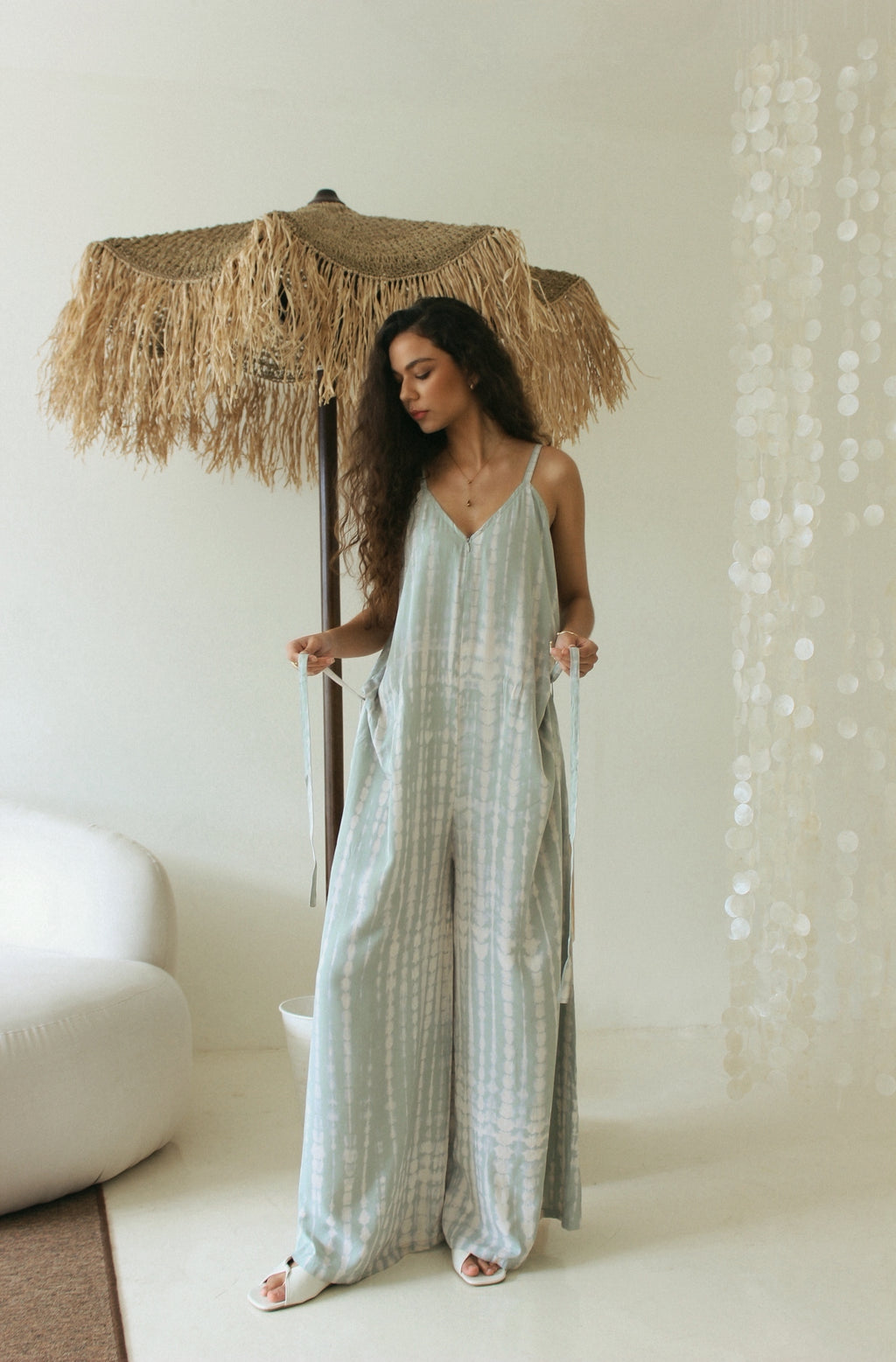 Front view of sage green Bali tie-dye jumpsuit with flowing silhouette - Tulalara