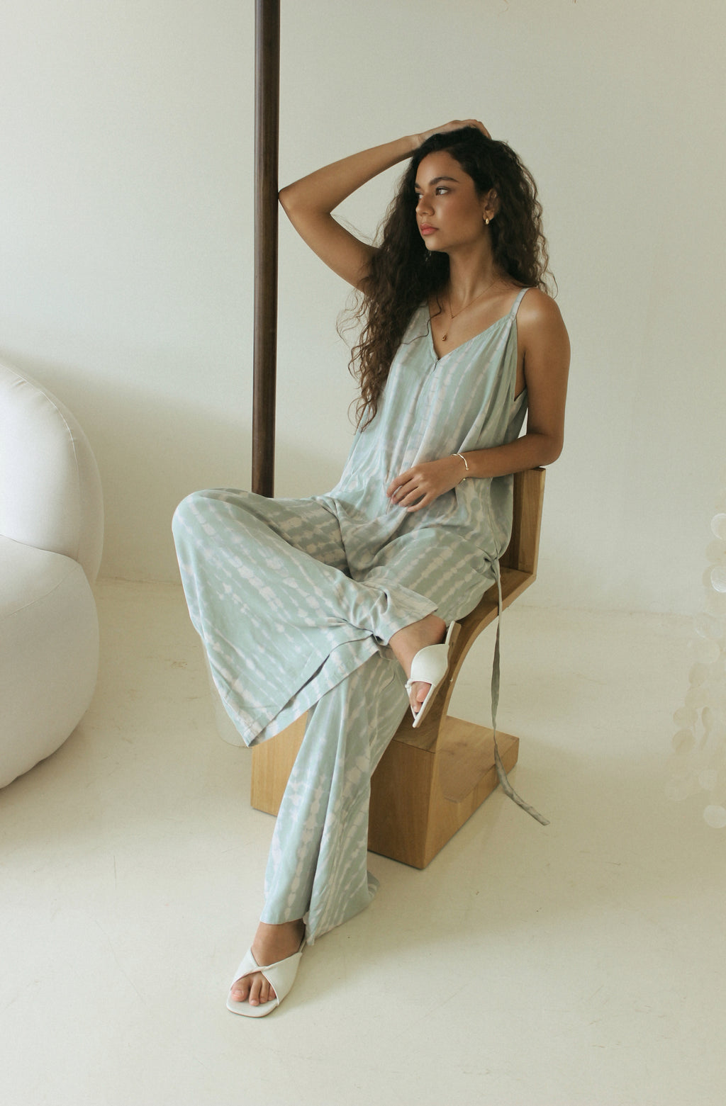 Relaxed resort wear jumpsuit featuring a flowing wide-leg silhouette in sage green Bali tie-dye - Tulalara