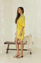 Side view of yellow beach mini kaftan dress with Bali tie-dye pattern - Tulalara